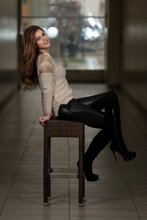 Beautiful Young Brown Model Sitting On The Chairの写真素材