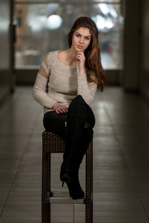 Beautiful Young Brown Model Sitting On The Chairの写真素材