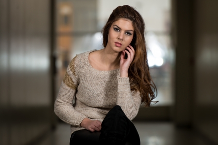 Beautiful Young Brown Model Sitting On The Chairの写真素材