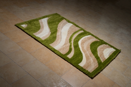Single Green Carpet Folded On Floorの写真素材