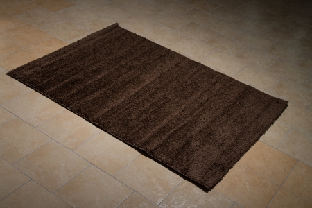 Single Brown Carpet Folded On Floorの写真素材