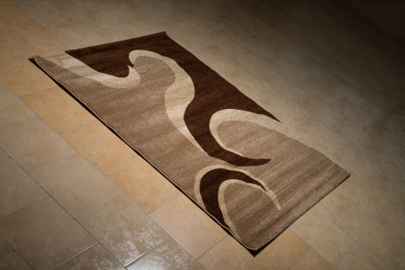 Single Brown Carpet Folded On Floorの写真素材