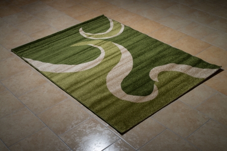 Single Green Carpet Folded On Floorの写真素材