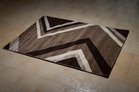 Single Brown Carpet Folded On Floorの写真素材