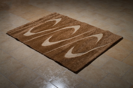 Single Brown Carpet Folded On Floorの写真素材