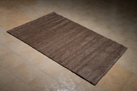 Single Brown Carpet Folded On Floorの写真素材