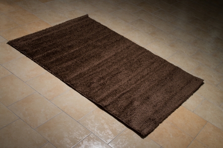 Single Brown Carpet Folded On Floorの写真素材
