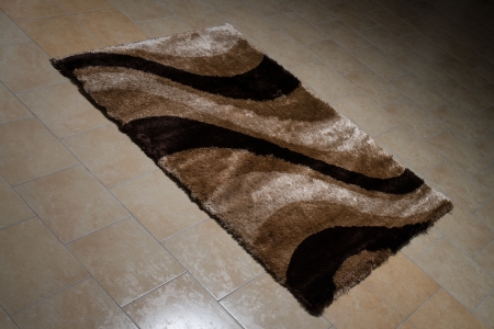 Single Brown Carpet Folded On Floorの写真素材
