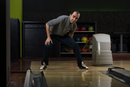 Smiling Young Man Playing With A Bowling Ballの写真素材