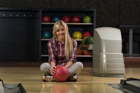 Cheerful Young Women Holding Bowling Ballの写真素材