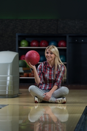 Happy Bowler Sitting At The Bowling Alleyの写真素材
