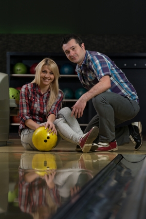 Man Teaching Woman Bowlingの写真素材