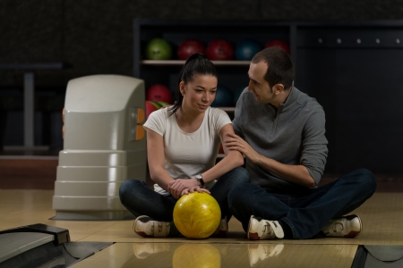 Man Teaching Woman Bowlingの写真素材