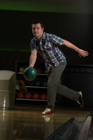 Smiling Young Man Playing With A Bowling Ballの写真素材