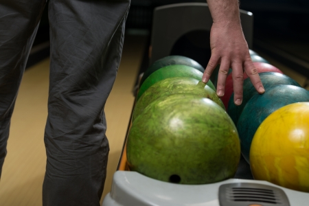 Holding Ball Against Bowling Alleyの写真素材