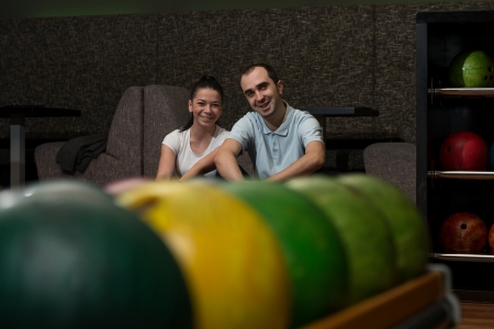 Beautiful Cheerful Couple Talking At The Bowling Alleyの写真素材
