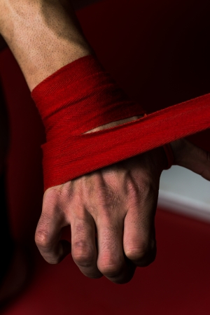 Boxer Putting On Straps Preparing For Combatの写真素材