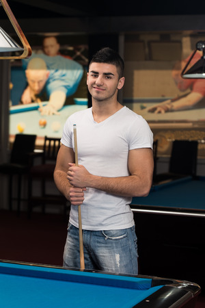Smiling Happy Man Playing Billiardの写真素材