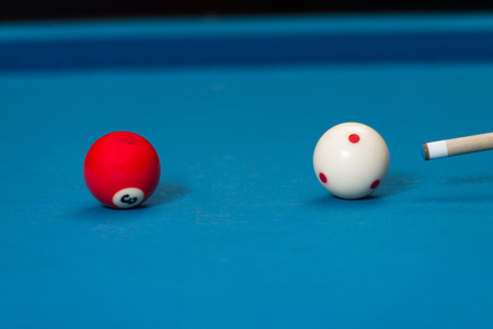 Man Playing Pool About to Hit Ballの写真素材