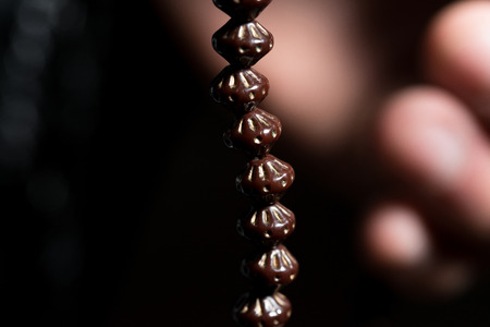 Close-Up Of Young Muslim Man With Rosary Praying In Mosqueの写真素材