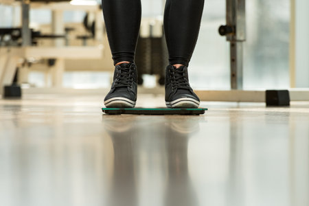Pair Of Legs Standing On A Scale