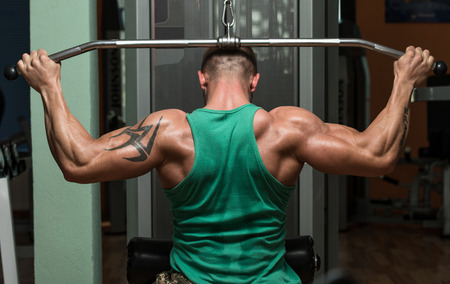 Young Man Doing Heavy Weight Exercise For Backの写真素材