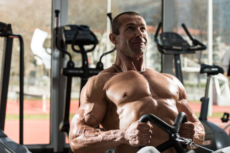 Healthy Male Doing Back Exercises In The Gym