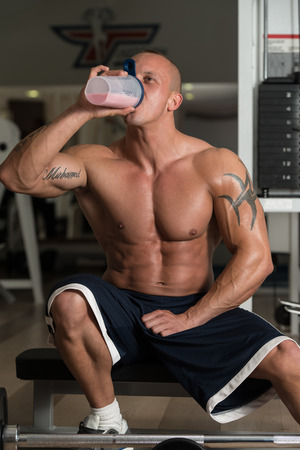 Handsome Muscular Man Drinking Protein Drinkの写真素材