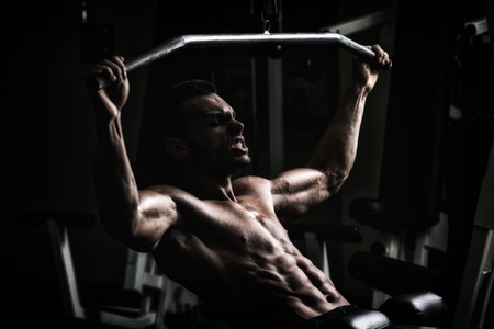 Young Man Doing Heavy Weight Exercise For Backの写真素材