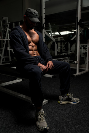 Portrait Of A Physically Fit Mature Man In A Healthy Club With Dramatic Lightingの写真素材