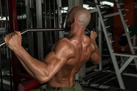 Mature Man Doing Back Exercises In The Gym