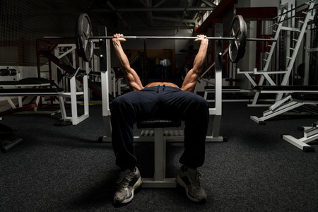 Mature Man In Gym Exercising On The Bench Pressの写真素材