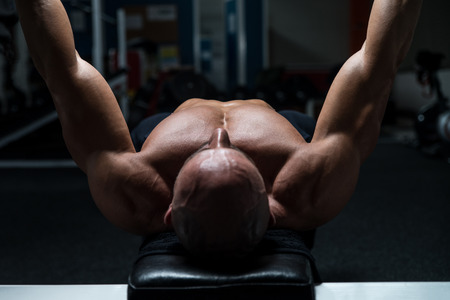 Mature Man In Gym Exercising On The Bench Pressの写真素材