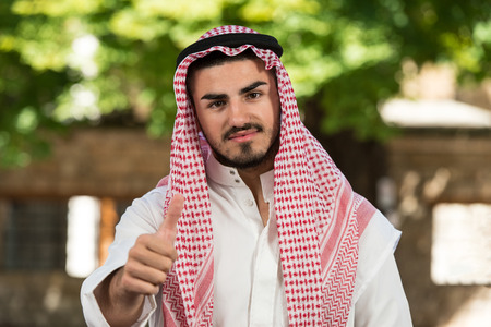 Young Businessman Wearing A Traditional Cap Dishdashaの写真素材