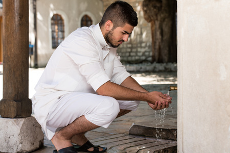 Muslim Man Preparing To Take Ablution In Mosqueの写真素材