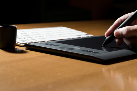 Closeup Of One Hand Drawing On A Computer Graphics Tabletの写真素材