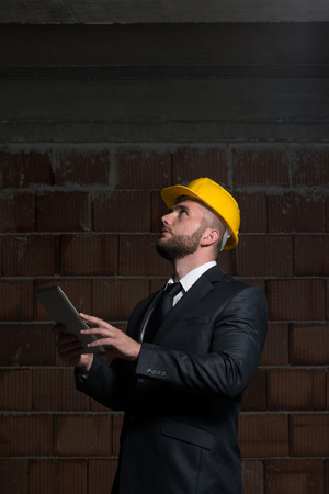 Portrait Of Construction Master With Personal Computer In Handsの写真素材