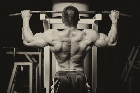 Male Bodybuilder Doing Heavy Weight Exercise For Backの写真素材