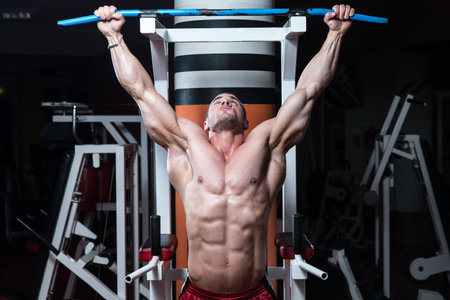 Male Bodybuilder Doing Heavy Weight Exercise For Back
