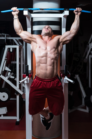Male Bodybuilder Doing Heavy Weight Exercise For Backの写真素材