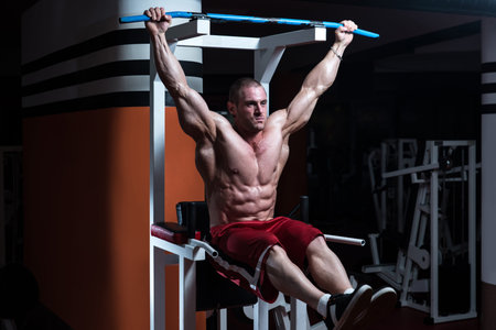 Handsome Man Exercising His Abs At The Gym