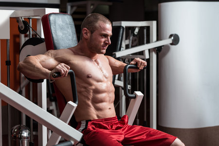 Male Bodybuilder Doing Heavy Weight Exercise For Chest