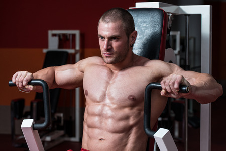 Male Bodybuilder Doing Heavy Weight Exercise For Chestの写真素材