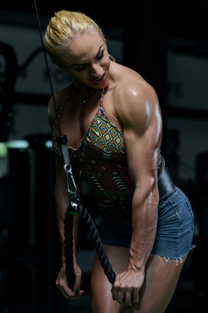 Young Woman Doing Heavy Weight Exercise For Tricepsの写真素材