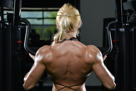 Female Bodybuilder Doing Heavy Weight Exercise For Back In Gym