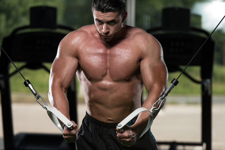 Bodybuilder Is Working On His Chest With Cable Crossover In Gymの写真素材