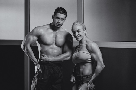 Strong Man And Woman Posing Bodybuildingの写真素材