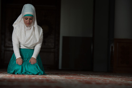 Young Muslim Woman Praying In Mosqueの写真素材