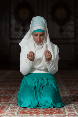 Young Muslim Woman Praying In Mosqueの写真素材