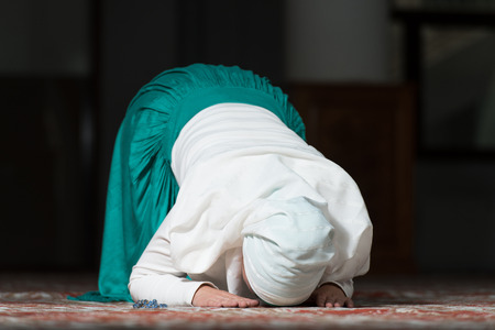 Young Muslim Woman Praying In Mosqueの写真素材